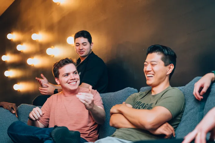 Men laughing together at a Dinner Group